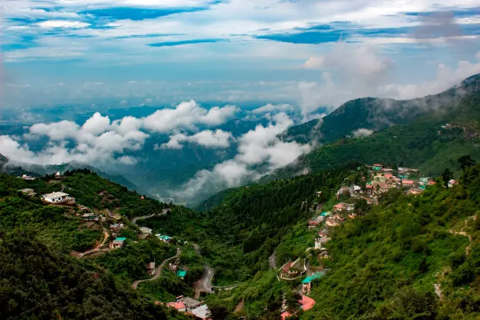 Breathtaking mountain landscape-mountainjunkey a lush Himalayan valley in Uttarakhand featuring glowing sunset hues and terraced greenery-mountain-junkey