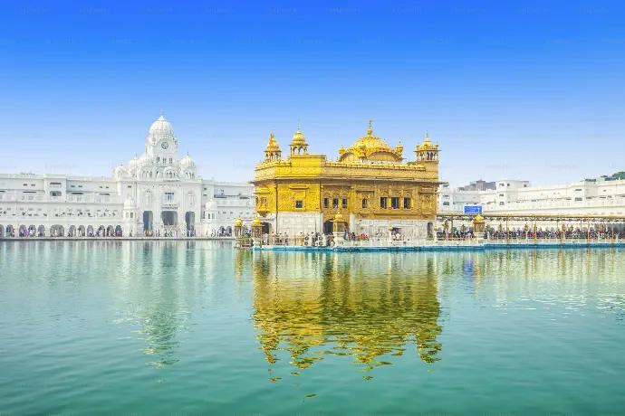 Golden Temple Amritsar in daytime with reflections Golden Temple Amritsar daytime reflection on the sarovar pool